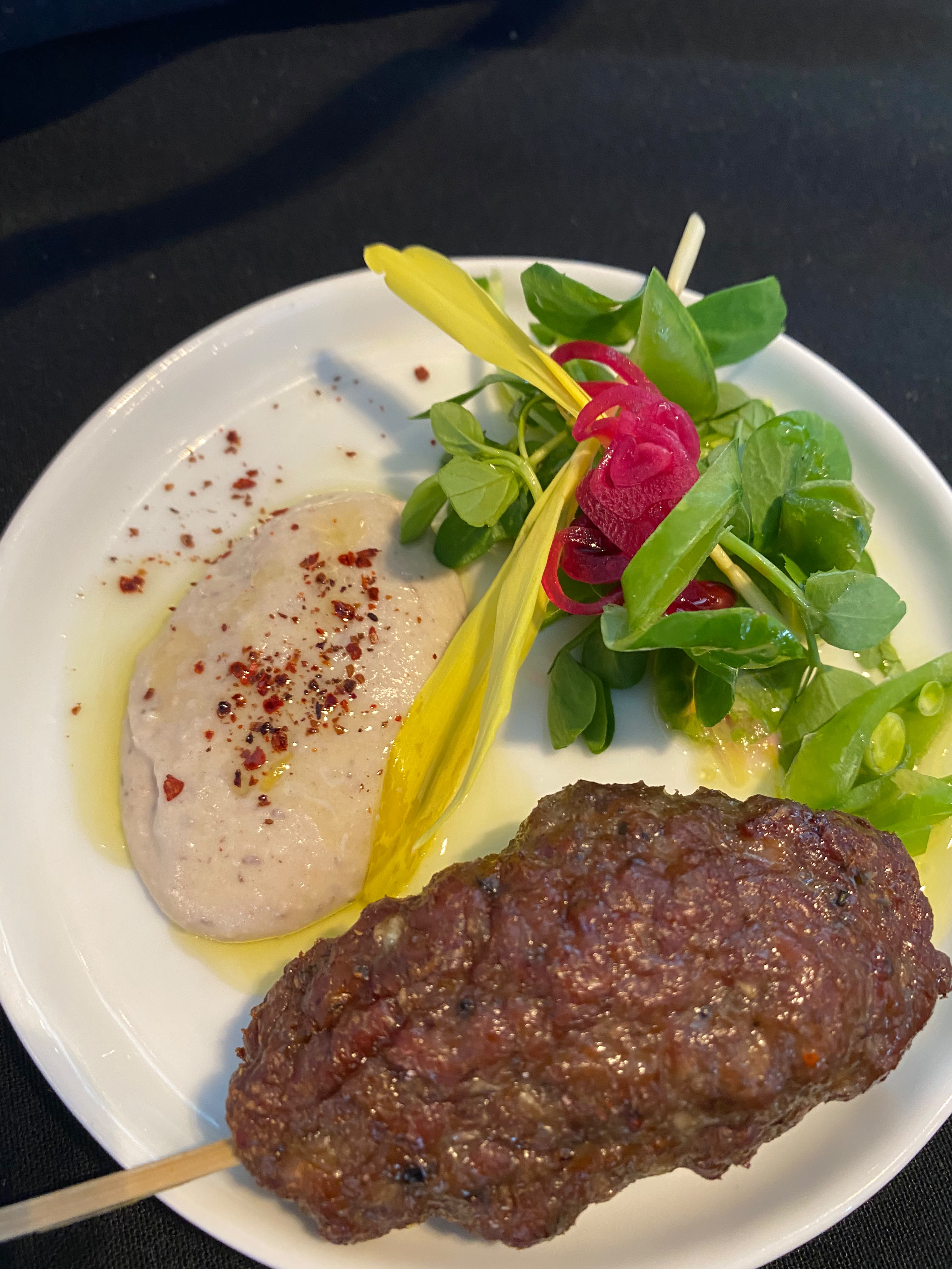Lamb Kebab w Hummus, Pea Tendrils, Pickled Red Onion, Sumac
